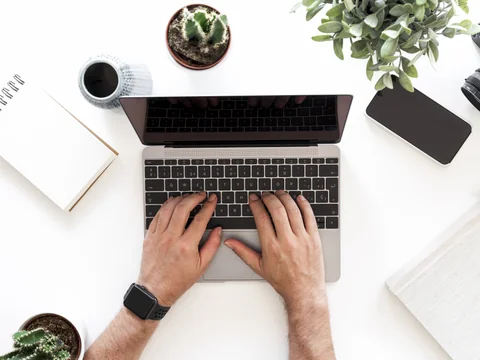 Person working at a desk with phone notifications blocked and focus apps on screen