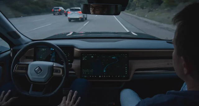 Rivian R1 electric vehicle using hands-free driving on a highway