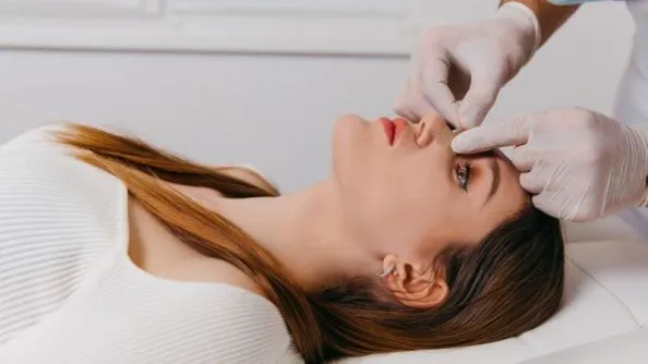 a woman having her nose check up