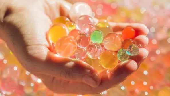 a person holding water beads